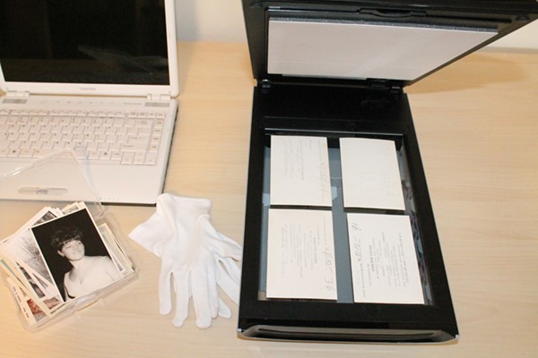 laptop, scanner, white gloves and old family photos to preserve your research